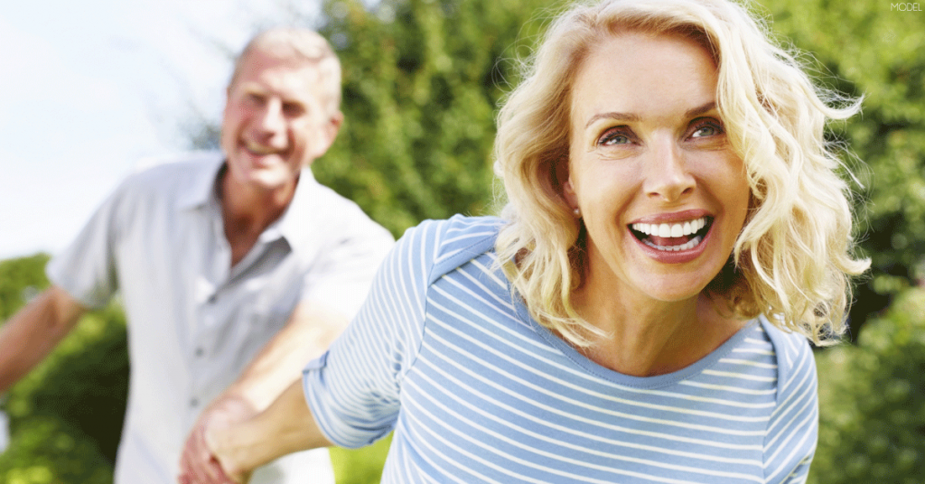 Woman and man demonstrating emotions of accomplishment and confidence after tummy tuck surgery