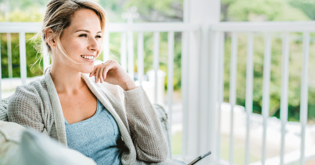 Woman asking herself what she hopes to achieve through undergoing breast augmentation surgery