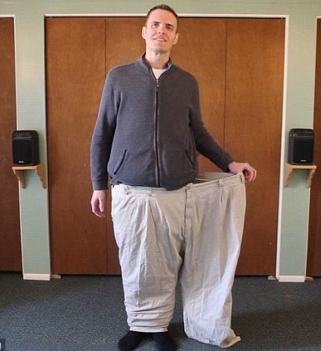 Brian Flemming wearing oversized pants stretching them out at the waist for comparison