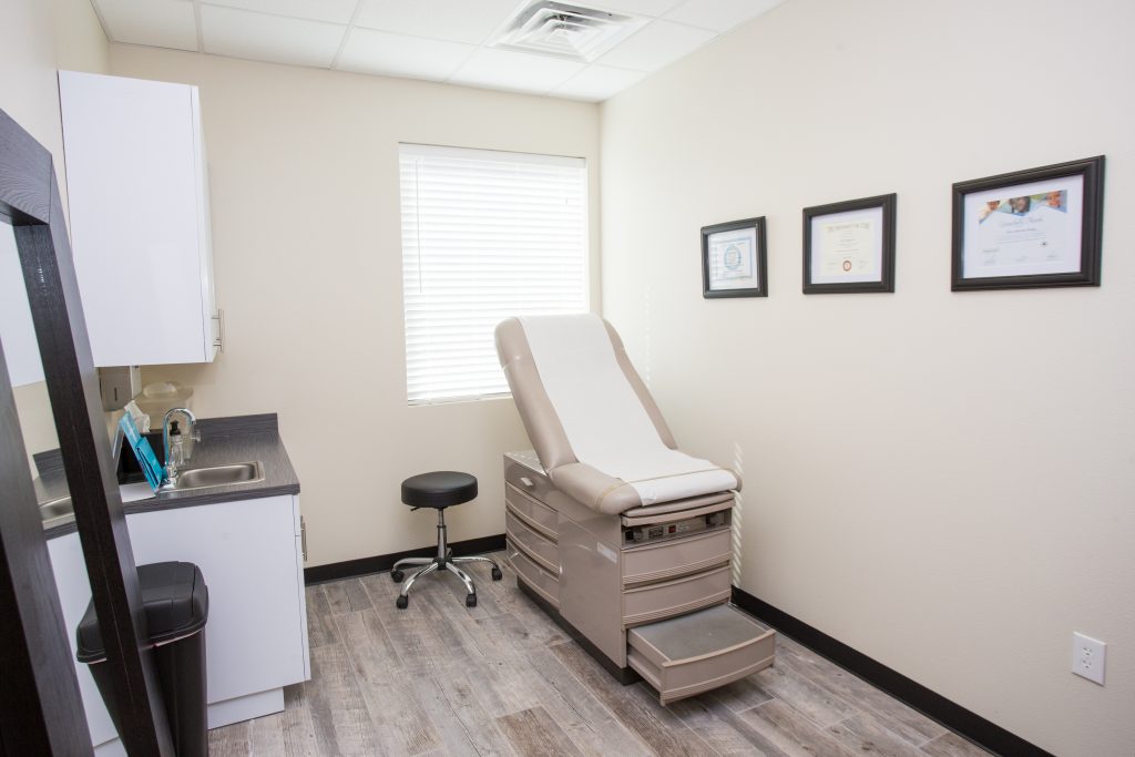 Austin plastic surgery exam room with reclining table and wood floors