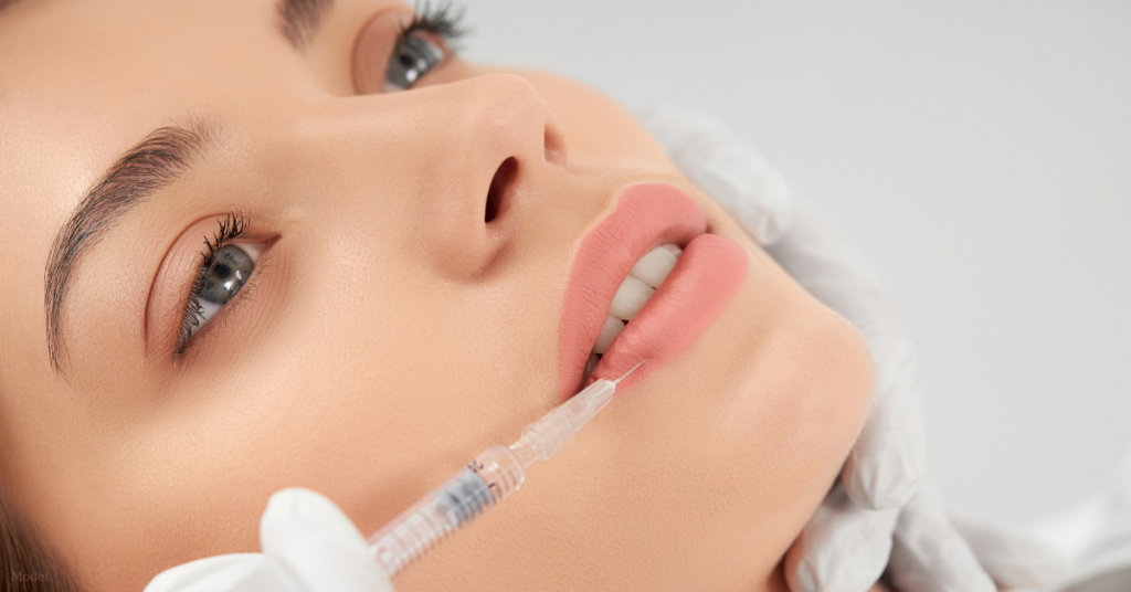 Woman having a lip filler procedure done