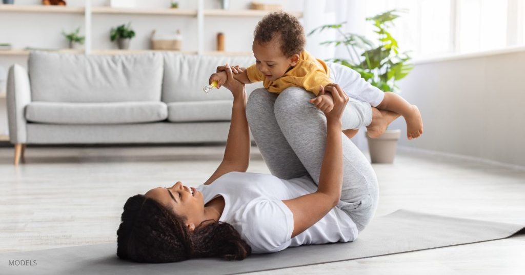 Mother and son (models) doing yoga indoors,